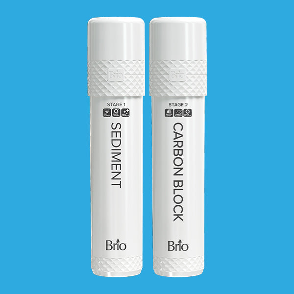 Two white Brio water filter cartridges labeled SEDIMENT (Stage 1) and CARBON BLOCK (Stage 2) with textured caps, standing upright on a blue background.
